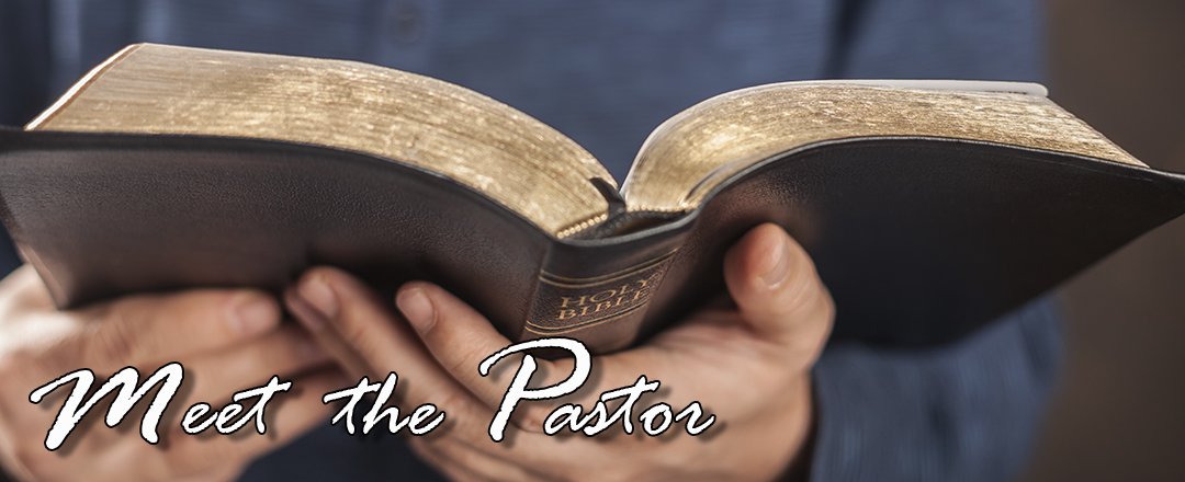 photo of hands holding open a Bible with the caption Meet the Pastor